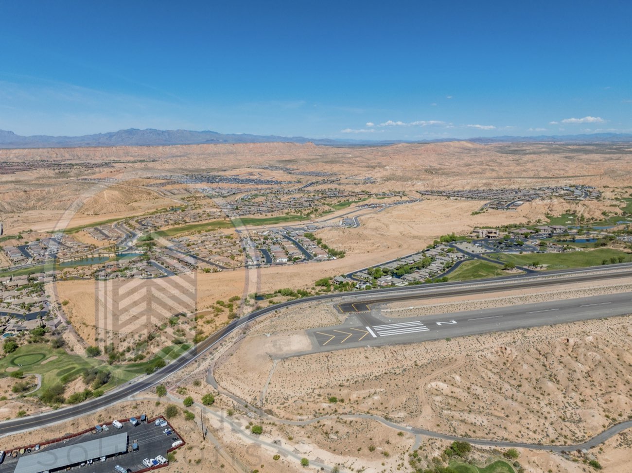 Aerial frame from a commercial shoot in a Las Vegas secondary market with an active non-towered runway in the frame — airspace checked before the flight, nothing to file
